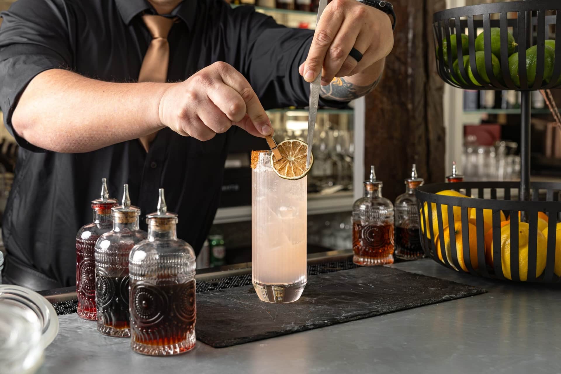 A cocktail being garnished